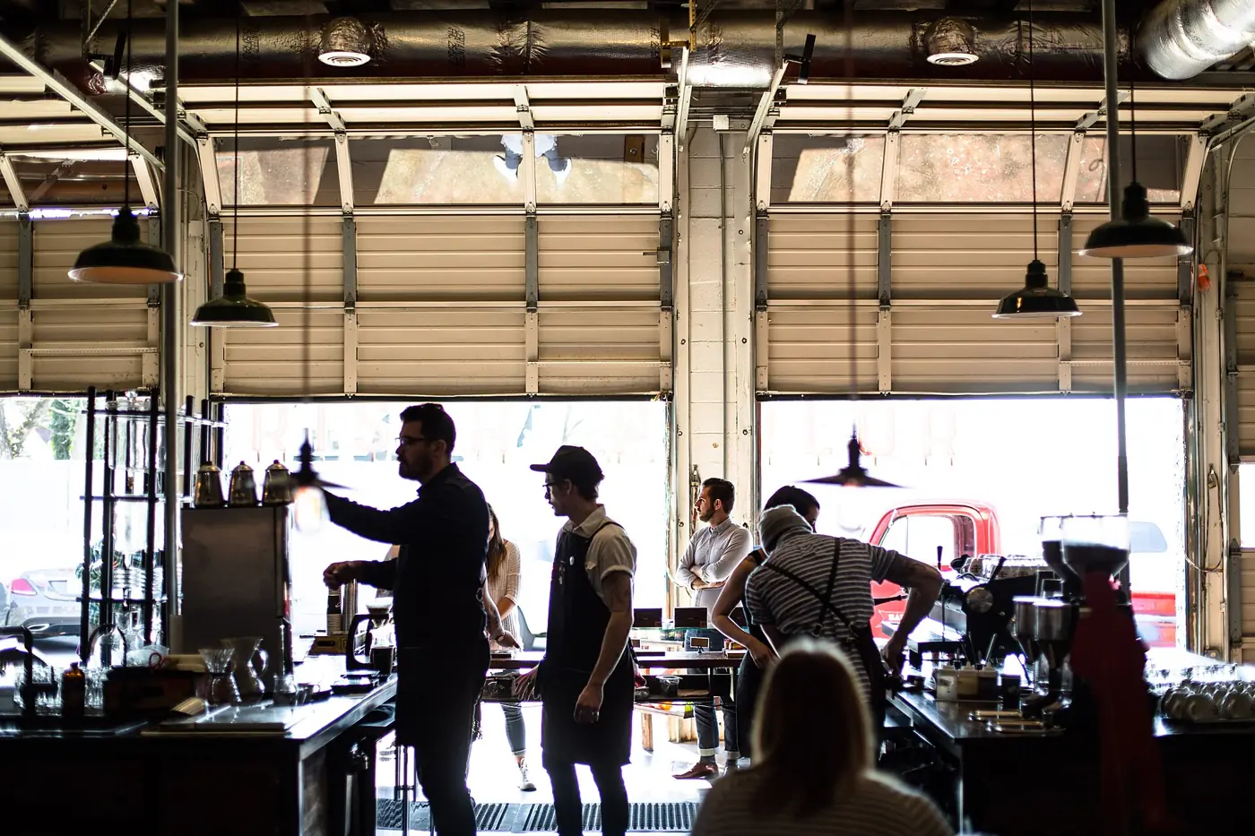 Baristas at work behind a coffee shop counter