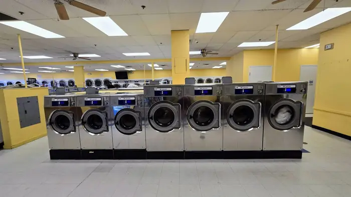 A row of commercial washing machines